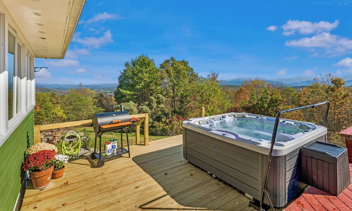 Cambridge House | Bright hilltop retreat with stunning mountain views, wrap-around windows, and cozy seating to take it all in. Nestled on a private, scenic property minutes from charming Cambridge village—perfect for a peaceful getaway year-round.
