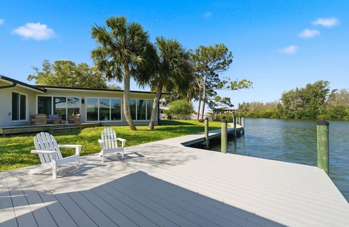 Cocoa Isles House | Luxury Waterfront Retreat Bikes, Hot Tub, Kayak, Walk to downtown Cocoa Beach.