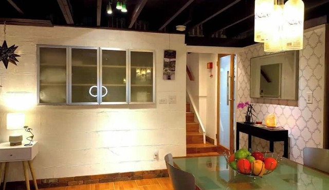 Live in this iconic East Side lower level apartment